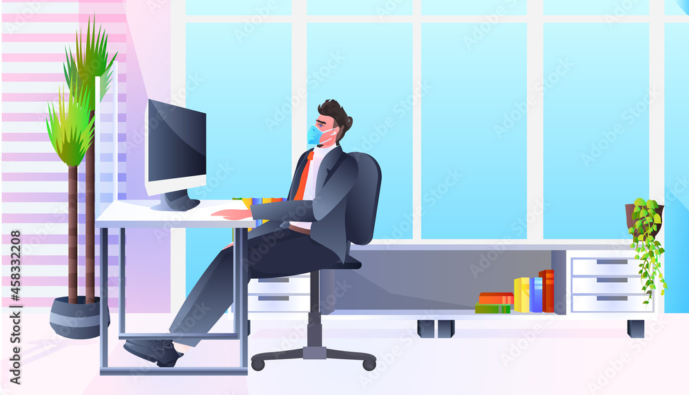 businessman in mask sitting at workplace business man working in office coronavirus quarantine concept businessman in mask sitting at workplace business man working in office coronavirus quarantine concept
