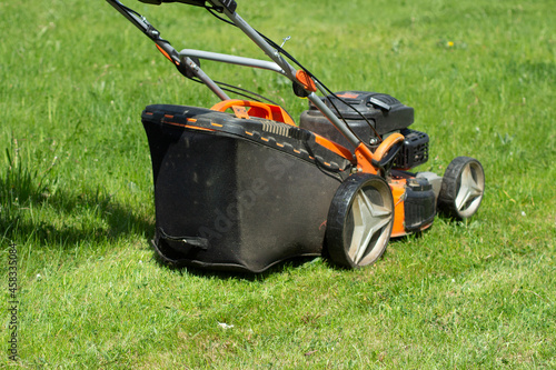 A lawn mower cuts the grass. A lawnmower shaves the lawn. Gardener's job.