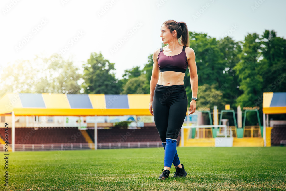 Young athletic woman stretches and prepares to run. strong sport woman