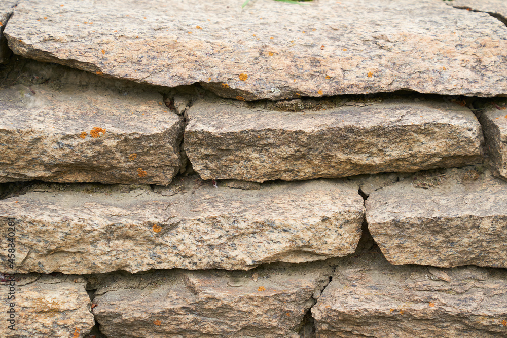 Close-up of a detailed picture of a stone wall. Old stone wall texture background for design and decor. High quality photo Close-up of a detailed picture of a stone wall. Old stone wall texture background for design and decor. High quality photo