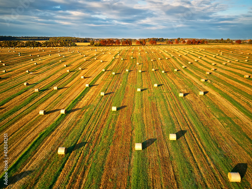 Obraz na płótnie Autumn landscape, straw bales on agricultural field. Haystacks fall season aerial view. w salonie