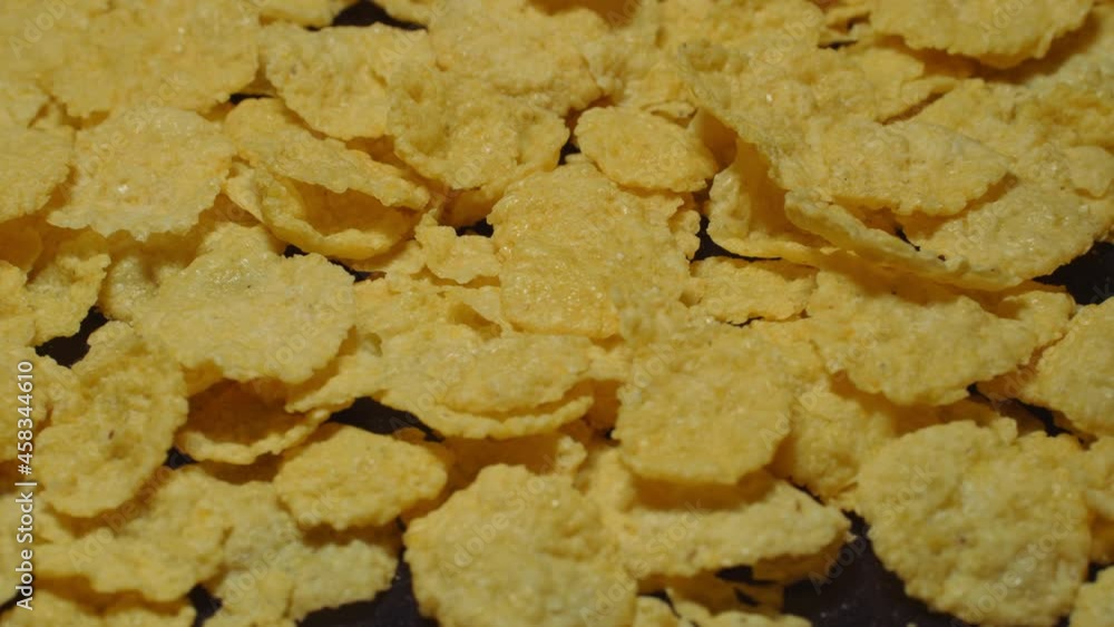 Rotating cornflakes on a black background. Rotating cornflakes on a black background.