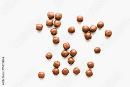 Chocolate dragee on a white background. Chocolate candies. Chocolate on a white background. 