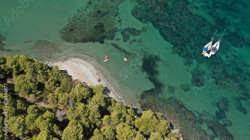 Fototapeta Naklejka Na Ścianę i Meble -  Aerial drone photo of famous bay and small traditional village of Atsitsa covered in pine trees and natural sandy beaches, Skiros island, Sporades, Greece