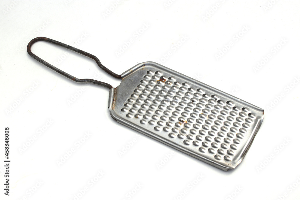 Close-up view of old used cheese grater with a little bit rusty isolated on a white background Close-up view of old used cheese grater with a little bit rusty isolated on a white background