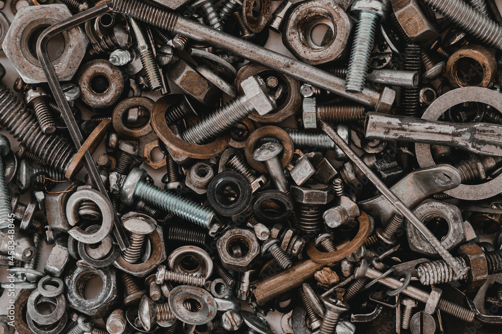 Bolts, nuts, nails on a white background. Close-up. Bolts, nuts, nails on a white background. Close-up.