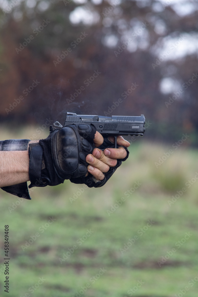 hand holding gun hand holding gun
