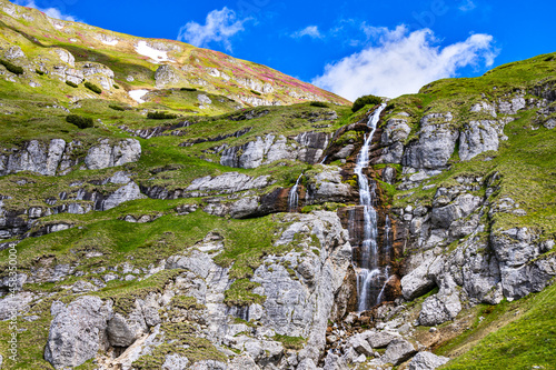 Obarsia Ialomitei waterfall in the Bucegi mountains in Romania photo