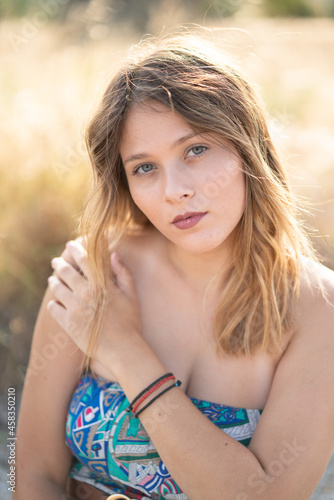 Natural Looking Young Beautiful Woman with Hazel eyes posing in the fields, no post editing