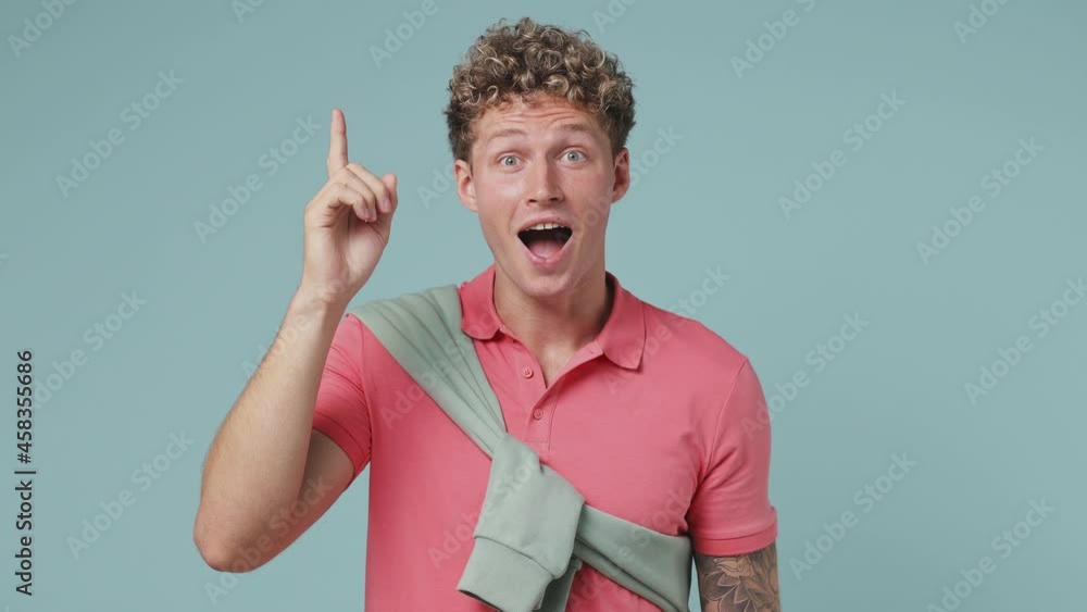 Insighted smart proactive young curly man 20s wear pink t-shirt looks ...