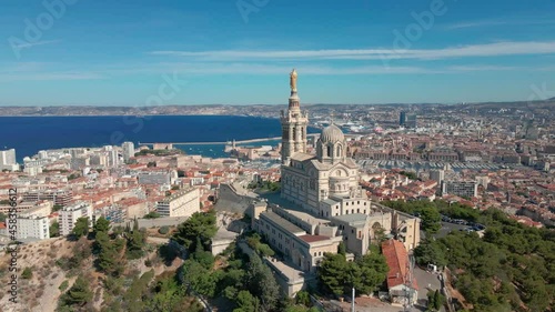 Marseille, France aerial video with view of basilica Notre Dame de la Garde, old city center and port and blue Mediterranean sea coast, warm sunny day. Summer holiday vacation tourism destination. photo