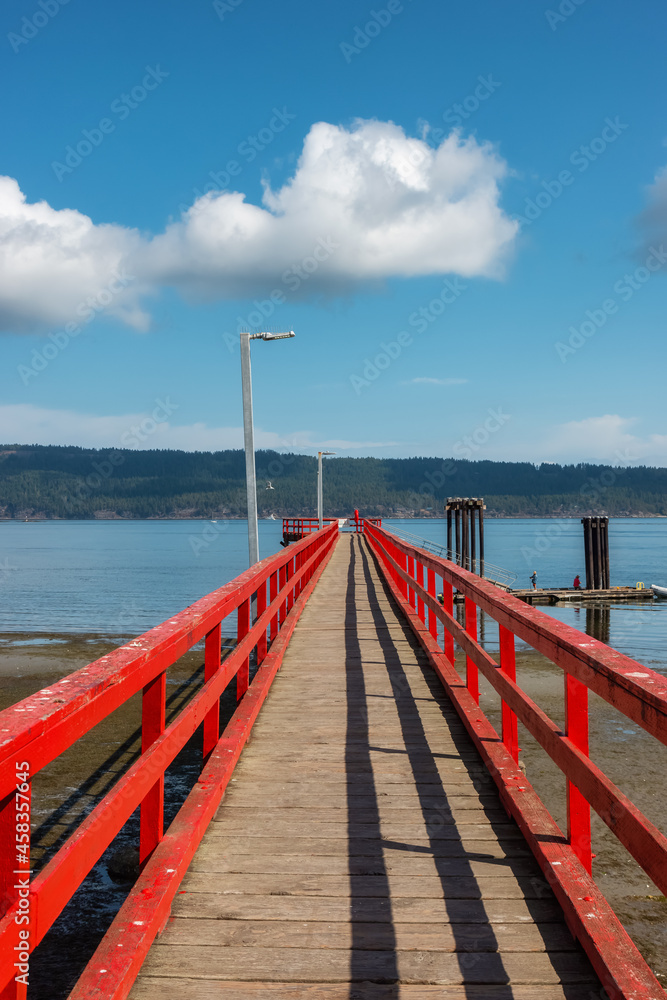 Wooden Pier by the Pacific Ocean West Coast. Sunny Summer Day. Fernwood Point Beach, Salt Spring Island, British Columbia, Canada.