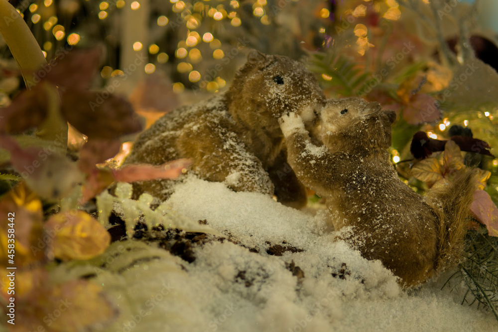 puppet squirrels kiss in a fairy snowy forest. Christmas installation