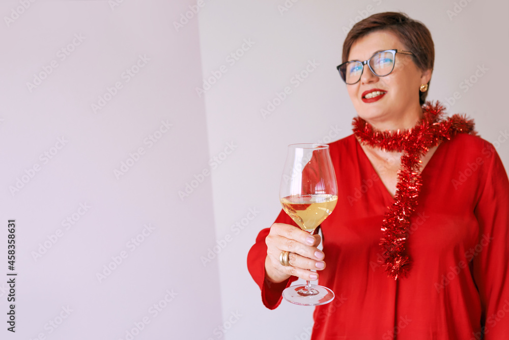 stylish mature senior woman in red blouse with glass of white wine celebrating new year. Fun, party, style, lifestyle, alcohol, celebration concept stylish mature senior woman in red blouse with glass of white wine celebrating new year. Fun, party, style, lifestyle, alcohol, celebration concept