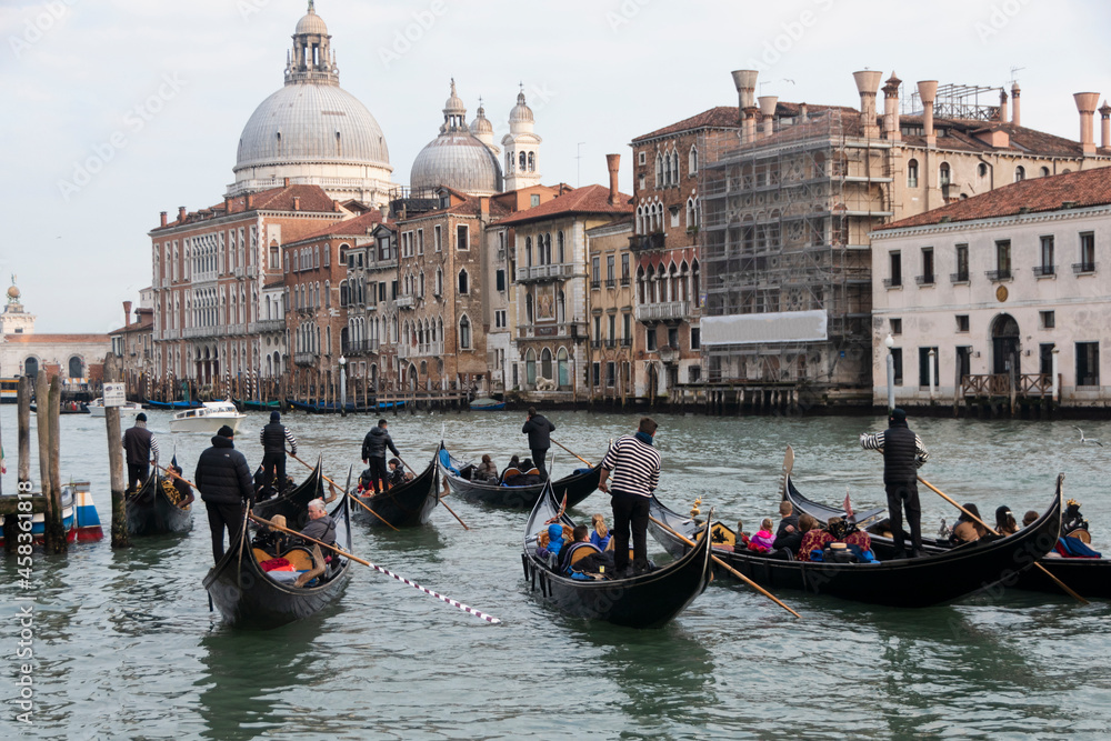 A group of gondolas sailing in the Grand Canal in Venice, Italy