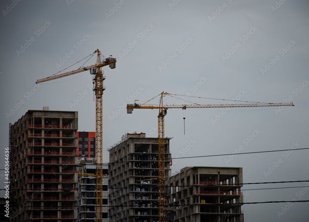 Three houses under construction with two crane Three houses under construction with two crane