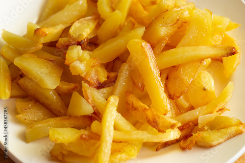 a plate of mouth-watering fresh fried potatoes with a golden crust