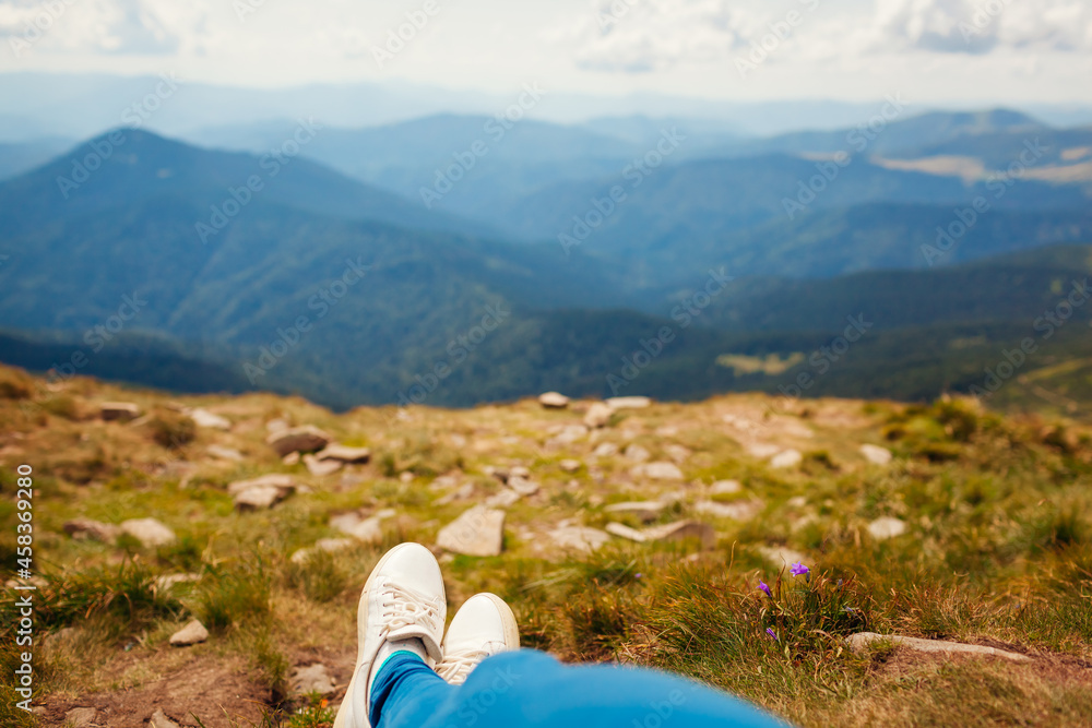 Hiking in Carpathian mountains. Hiker woman relaxing enjoying landscape. Traveling in summer Ukraine Hiking in Carpathian mountains. Hiker woman relaxing enjoying landscape. Traveling in summer Ukraine