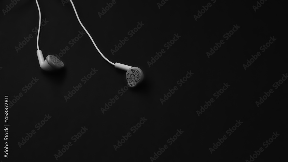 white wired headphones view on black background white wired headphones view on black background