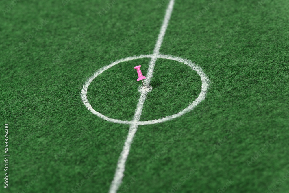 Push pin in the center of the soccer field.