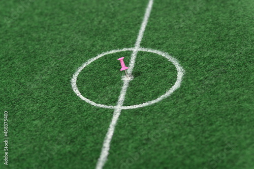 Push pin in the center of the soccer field.