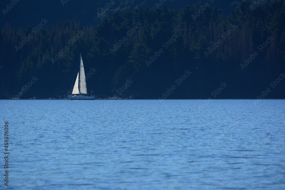 sailboat sailing in lake of patagonia