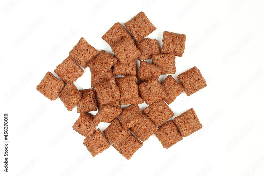 Pile of chocolate pillows isolated on white background.Dry crispy dessert Pile of chocolate pillows isolated on white background.Dry crispy dessert