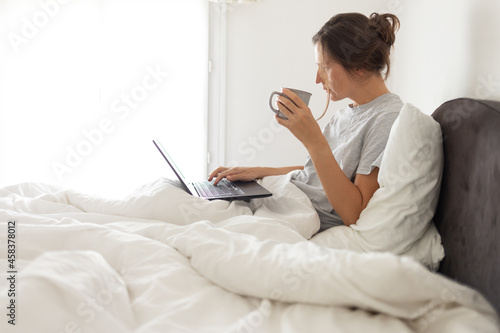cell phone addict woman awake in bed, stay home concept