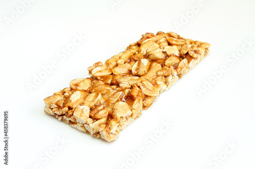 Thin protein bar made of peanuts isolated on white background.