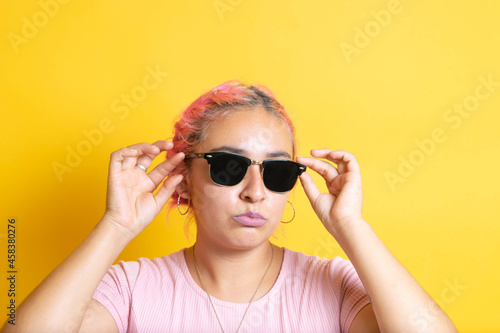 portrait of young Mexican woman wearing sunglasses. latin