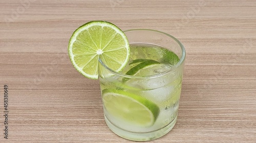 Lemon Fruit Caipirinha from Brazil on wooden background. Space for text.