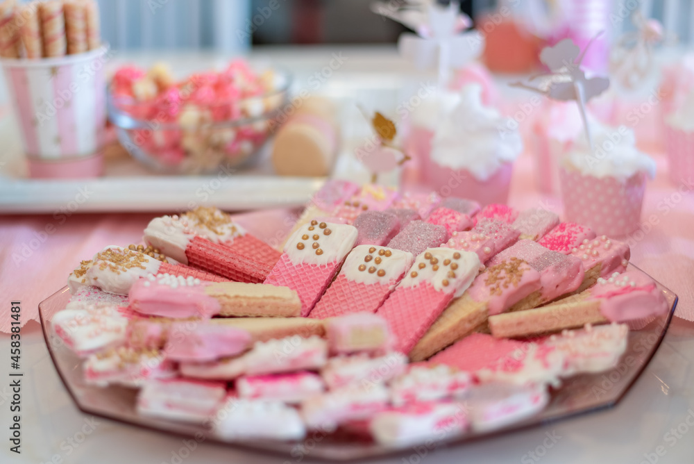 Pink wafter cookies with icing and sprinkles Pink wafter cookies with icing and sprinkles