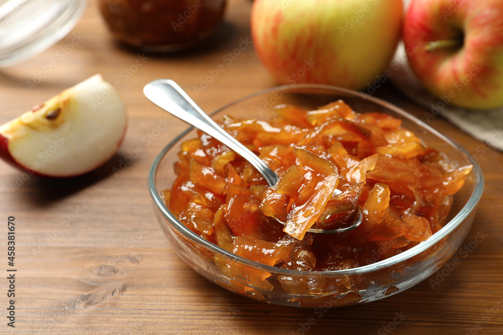 Tasty apple jam in glass bowl and fresh fruit on wooden table, closeup Tasty apple jam in glass bowl and fresh fruit on wooden table, closeup