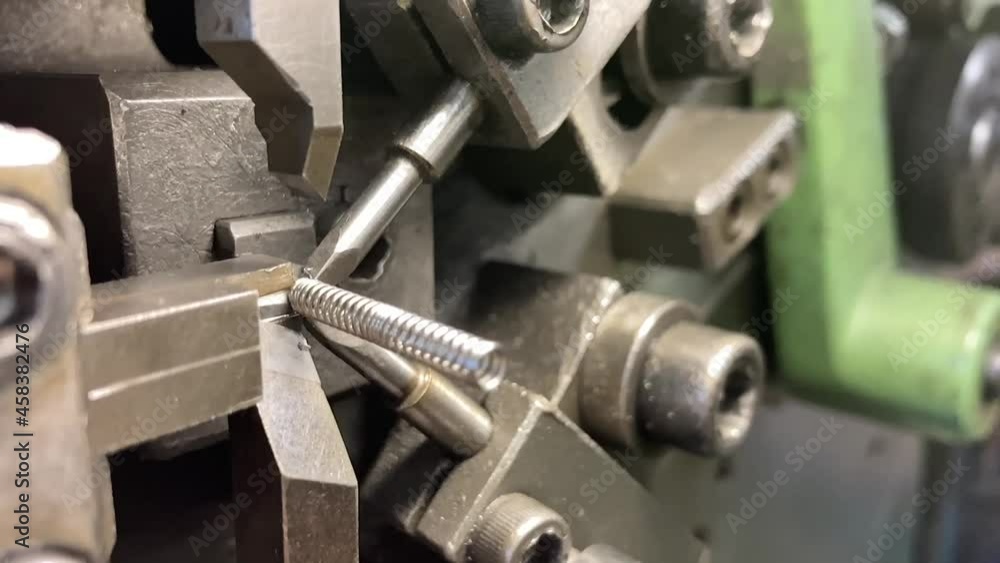 Spring winding on the machine. Manufacturing of a spring in production.Slow motion video. Spring winding on the machine. Manufacturing of a spring in production.Slow motion video.