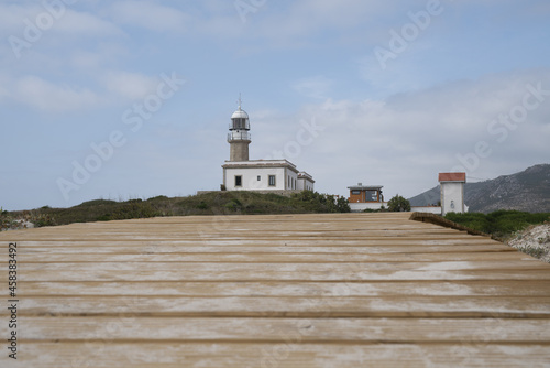 Larino lighthouse in Galicia, Spain against the sky photo