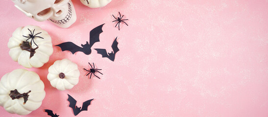 Halloween Trick or Treat Social Media Web Banner. Modern pink Halloween theme flatly background with white skull, pumpkins, lollipops and bats. Negative copy space.