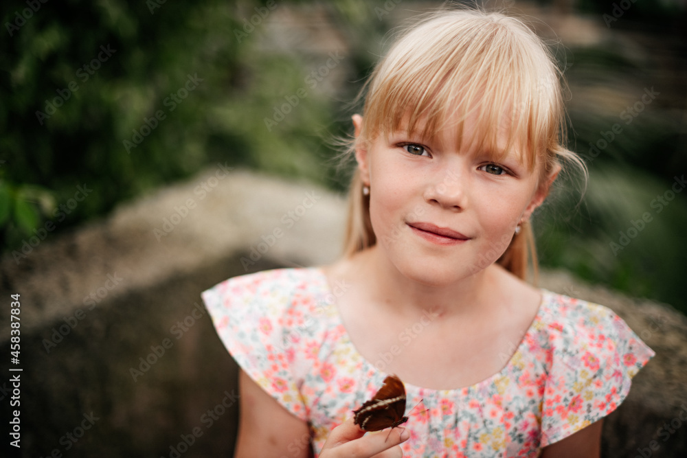 portrait of a little blonde girl with a lively beautiful butterfly, amazing nature, happy childhood. portrait of a little blonde girl with a lively beautiful butterfly, amazing nature, happy childhood.