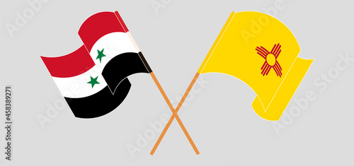 Crossed and waving flags of Syria and the State of New Mexico