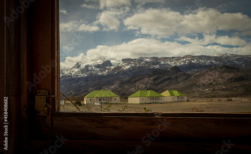 Houses in the middle of the mountains seen through the window