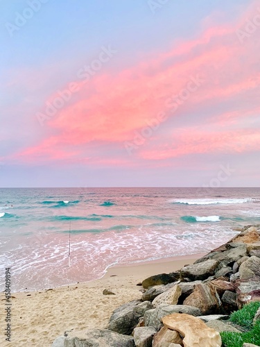 Pink Clouds over the Pacific Ocean at Cronulla Beach as the sun sets. No people, copy space.