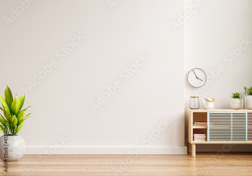 Mockup of an interior wall in a living area with a cabinet and an empty white wall background.