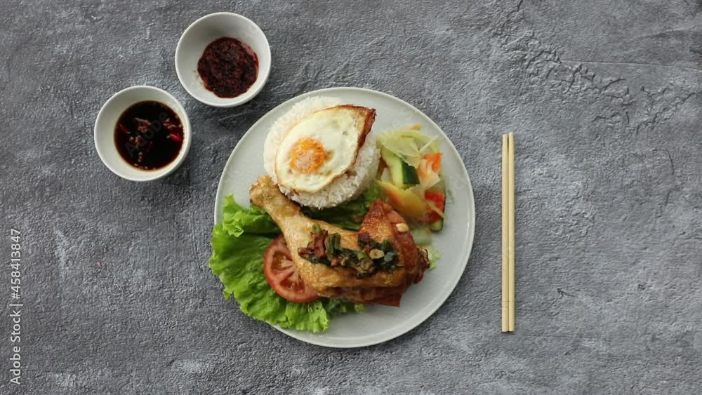 Male hands placing down chicken and egg asian salad onto table surface. Male hands placing down chicken and egg asian salad onto table surface.