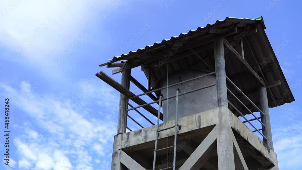 Water tank house, white clouds and blue sky Water tank house, white clouds and blue sky