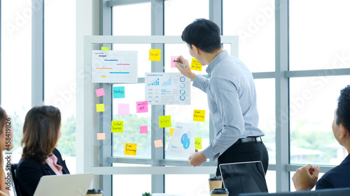 Business meeting for presenting business plan information at office, Asian man explaning business chart to team, business people, success in business concept