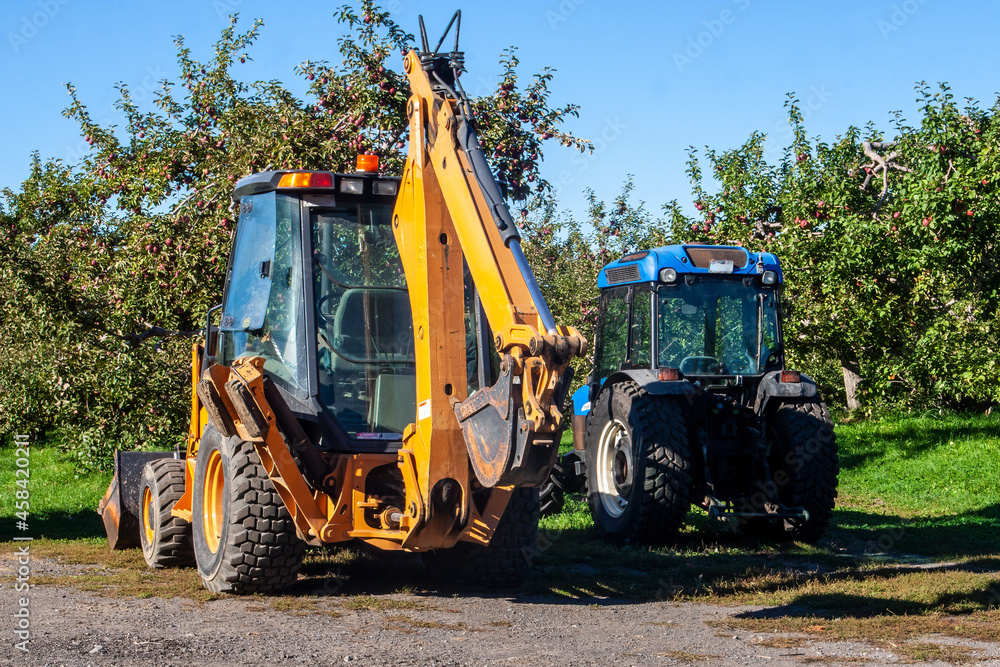 Excavator Tractor in an Apple Orchard