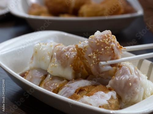 Zhaliang (fried dough rice noodle rolls) or Chee Cheong Fun You Tiao. Singapore Chee Cheong Fun Youtiao on Chopsticks.