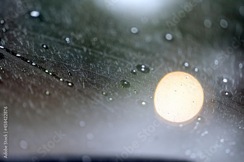 Shot from inside of a vehicle looking through the windshield while passing through traffic during a storm photo