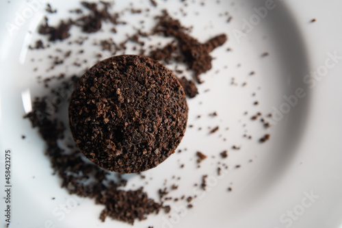 Espresso coffee puck on a dish. Coffee grounds can be used as a fertilizer.