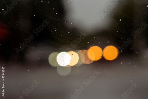 Fototapeta Naklejka Na Ścianę i Meble -  Shot from inside of a vehicle looking through the windshield while passing through traffic during a storm