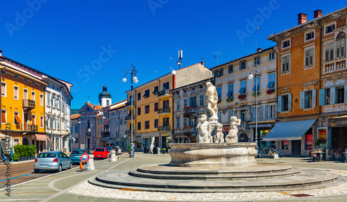 View of central square of Gorizia Piazza della Vittoria (Victory Square) with Neptune Fountain at sunny day, Italy